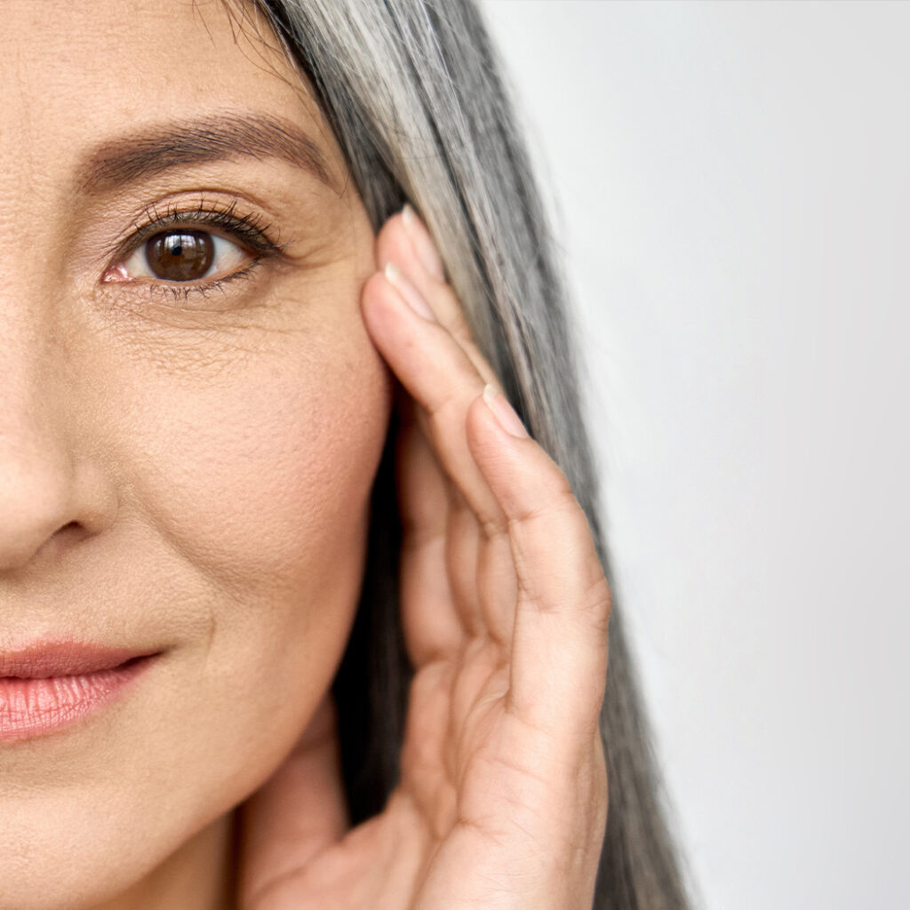 Middle aged woman with white and grey streaks of hair