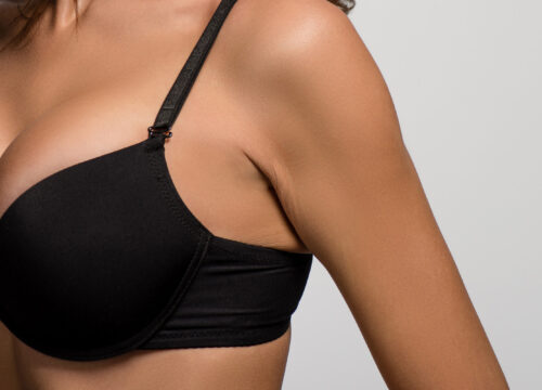 Photo of a woman's black bra and chest area