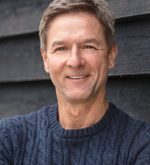 Closeup on a man in a dark blue sweater