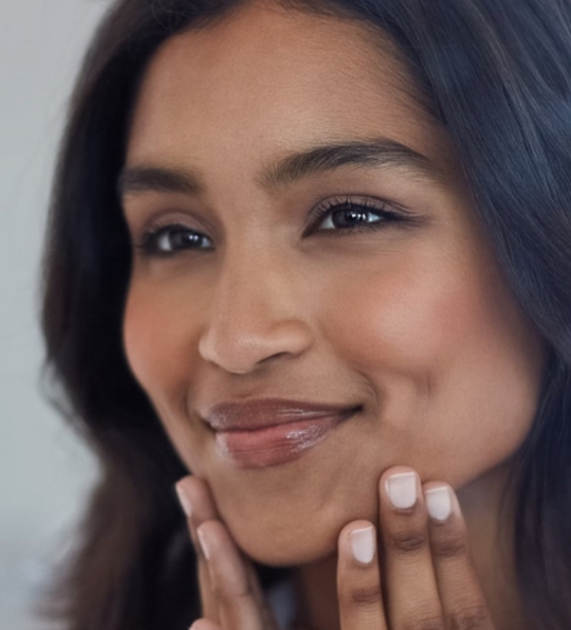 Photo of a beautiful woman with dark hair touching the lower part of her face